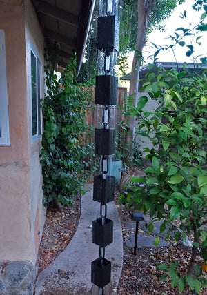 Square Kenchiku Rain Chain in Black with rain falling through the cups